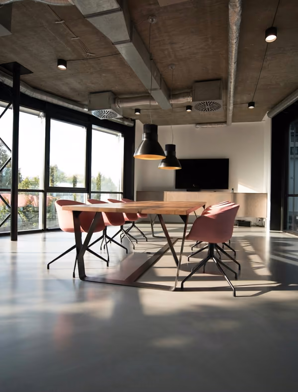 A bright meeting room with a long wooden table